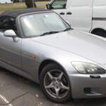 Para celebrar su 50º aniversario, Honda lanzó el S2000, un deportivo que desafiaba los límites de la ingeniería. Su motor atmosférico de 2.0 litros entregaba 240 CV y alcanzaba 9,000 RPM, un récord para un coche de calle confiable. Su diseño equilibraba rendimiento extremo y fiabilidad, convirtiéndolo en un icono del automovilismo japonés.