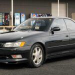 El Toyota Mark II JZX90, lanzado en los años 90, se convirtió en un clásico moderno gracias a su equilibrio entre lujo y deportividad. En sus versiones más potentes montaba el legendario motor 1JZ-GTE de seis cilindros en línea y 280 CV, con tracción trasera y opción de cambio manual. Esto lo convirtió en un coche ideal para el drifting, junto a sus hermanos Chaser y Cresta. Su diseño, especialmente la zaga con barra de luces trasera continua, lo hace inconfundible. Hoy en día, sigue siendo muy buscado por coleccionistas y aficionados a la cultura JDM.