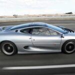 El Jaguar XJ220 se presentó como el superdeportivo británico que cambiaría las reglas del juego. Inicialmente, Jaguar prometió un motor V12 y tracción total, pero la versión final, lanzada en 1992, se conformó con un motor V6 biturbo y tracción trasera. Esta discrepancia en las especificaciones enfureció a los compradores y causó una caída en las ventas. Solo 281 unidades fueron fabricadas, lo que convirtió al XJ220 en un modelo extremadamente raro. A pesar de sus comienzos difíciles, su impresionante rendimiento, con 542 CV y una velocidad máxima cercana a los 340 km/h, lo ha convertido en un objeto de culto, con precios que superan los $533,000 en el mercado de coleccionistas.