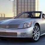 El Cadillac XLR nació de la necesidad de Cadillac de tener un coche insignia que destacara por su diseño y rendimiento. Utilizando la plataforma del Chevrolet Corvette C6, Cadillac creó un vehículo con techo rígido y motor V8 Northstar. A pesar de sus líneas elegantes y su desempeño robusto, el XLR no fue un éxito de ventas debido a la elección del motor, que no lograba impresionar tanto como el del Corvette. Sin embargo, el XLR sigue siendo un modelo que muchos consideran una pieza de coleccionista, con un diseño que ha envejecido con gracia.