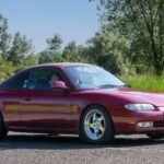 El Mazda MX-6 fue una opción elegante y refinada dentro de los coupés de dos puertas de los años 90. Con su diseño estilizado y limpio, sin los excesos de otros modelos deportivos de la época, el MX-6 ofreció una experiencia de conducción ágil y equilibrada. El modelo con motor V6 2.5L KL-DE producía 164 hp, lo que lo hacía sorprendentemente rápido y divertido de conducir. Además, algunos modelos venían con dirección en las cuatro ruedas (4WS), lo que le otorgaba una maniobrabilidad excepcional. Este coche estaba pensado para los entusiastas que valoraban la ingeniería sólida por encima de los alardes de diseño. Aún hoy, el MX-6 es un coche subestimado que sigue siendo accesible y divertido de manejar.