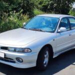 El Mitsubishi Galant de finales de los 90 es un ejemplo de un sedán medio que nunca recibió la atención que merecía. Con una diseño limpio y funcional, el Galant se centraba en ofrecer una experiencia de conducción cómoda y precisa, sin ostentaciones. Estaba disponible con motores como el V6 2.5L 6A13 o el eficiente 2.4L GDI I4, ambos conocidos por su fiabilidad y eficiencia. Su interior, sencillo pero bien diseñado, proporcionaba todo lo necesario sin complicaciones. Aunque la marca se centró más en modelos más llamativos, el Galant sigue siendo una opción sólida para aquellos que buscan un coche de calidad sin pagar una fortuna. Con el paso de los años, ha ganado una fama discreta como un coche fiable y duradero.