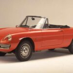 Los ingenieros italianos entendían que la caja de cambios debía ser tan apasionada como el motor, y la del Spider cumple perfectamente. La acción del cambio es mecánica y precisa, con “gates” que guían cada marcha como un baile bien ensayado. El embrague es progresivo y comunicativo, permitiendo sentir el punto de acople sin esfuerzo físico excesivo. Combinado con su motor Twin-Cam, incluso un viaje al supermercado se siente como una etapa de rally.