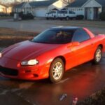 El Chevrolet Camaro fue el hermano más visible del Firebird y un auténtico símbolo de estatus juvenil en los años 90 y principios de los 2000. Las versiones Z28 y SS con motor LS1 ofrecían una relación prestaciones-precio espectacular. No obstante, el envejecimiento estético, la abundancia de versiones V6 y problemas conocidos como la fragilidad de la transmisión automática 4L60E han mantenido los precios contenidos. Sigue siendo rápido y carismático, pero el mercado aún lo trata como un deportivo de bajo presupuesto.