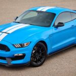 El Shelby GT350 es una bestia distinta. Prescinde de turbos y tracción total para apostar por un V8 atmosférico de 5.2 litros con cigüeñal plano, capaz de girar hasta las 8.250 rpm. El resultado son 526 CV y uno de los sonidos más memorables jamás montados en un coche de producción. Es visceral, inmediato y diseñado para ser exigido.