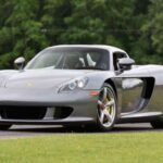 El Porsche Carrera GT nació de un proyecto cancelado de Le Mans, y eso se nota en cada detalle. Su V10 de 5.7 litros y 605 CV, junto a una caja manual y una suspensión derivada de competición, lo convierten en una máquina exigente y purista que no perdona errores.
