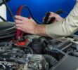 mechanic-attaching-jumper-cables-car-battery