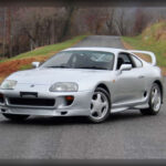 Hoy el Toyota Supra Mk4 es una leyenda absoluta, pero en sus primeros años muchos no imaginaban el potencial que escondía bajo su elegante diseño. Toyota desarrolló el famoso motor 2JZ-GTE biturbo con una capacidad casi ilimitada para soportar preparaciones extremas. Incluso completamente de serie, el Supra podía competir contra deportivos europeos muchísimo más caros, manteniendo además una fiabilidad mecánica casi indestructible que terminó convirtiéndolo en un mito del universo JDM.
