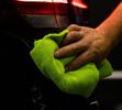 selective-focus-shot-man-cleaning-car-s-back-headlight-with-microfiber-cloth